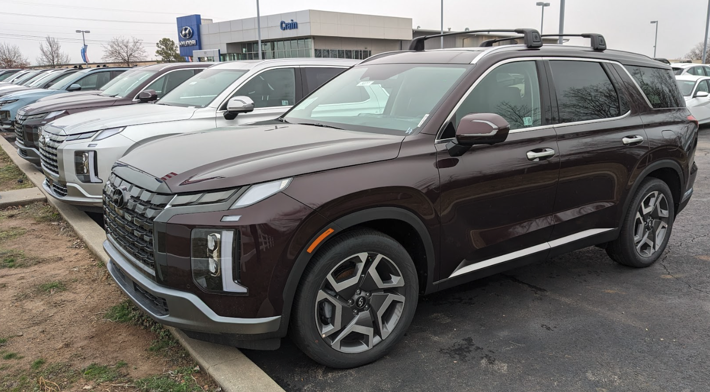 A row of Hyundai SUVs including a burgundy Palisade parked at Crain Hyundai of Fort Smith